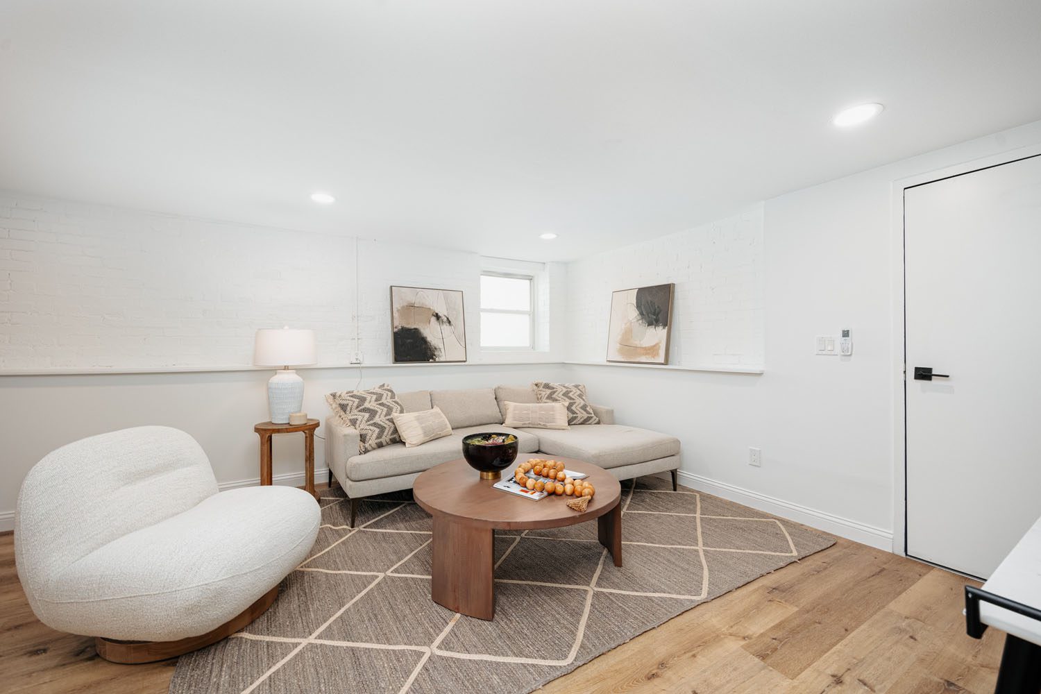 A cozy basement kitchen and dining area with modern appliances and a stylish decor.