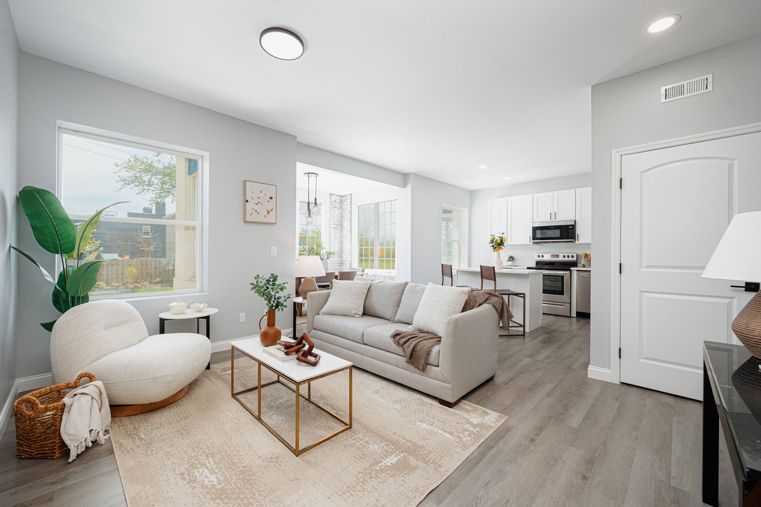 Interior of a living room featuring a couch, coffee table, and fireplace.